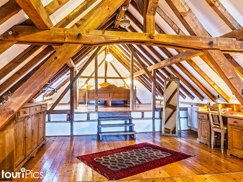 großzügige Suite mit Holzverkleidung im Dachgeschoss